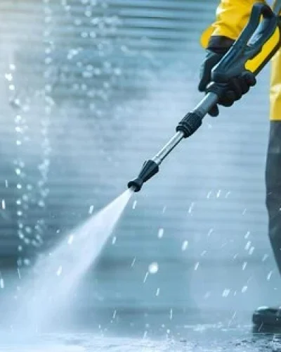 man-yellow-black-outfit-using-pressure-washer-water-puddle-concept-yellow-black-outfit-pressure-wash